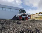 Bobcat S510 with combination bucket in a car park